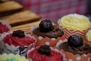 Cupcakes decorated with little icing and fruit on top