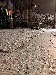 Photo of a snow covered sidewalk.